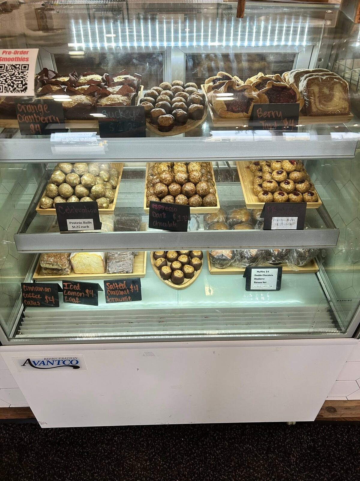 Cookies and energy bites on trays in the display case
