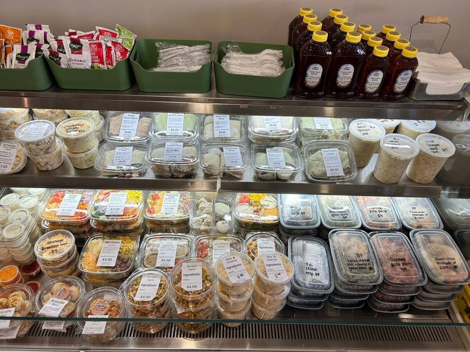 The cooler shelves full of labelled salads, wraps and tubs