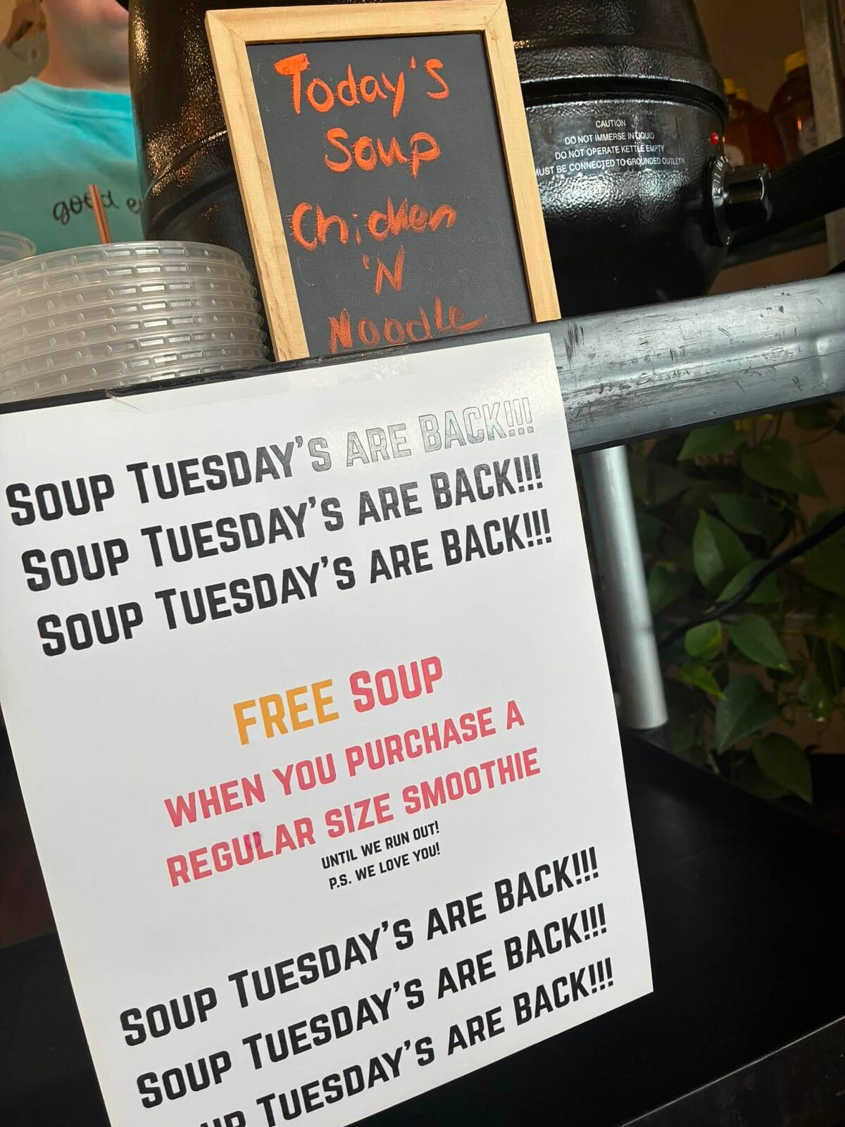 The Soup Tuesday sign next to the soup pot: free soup when you purchase a regular size smoothie