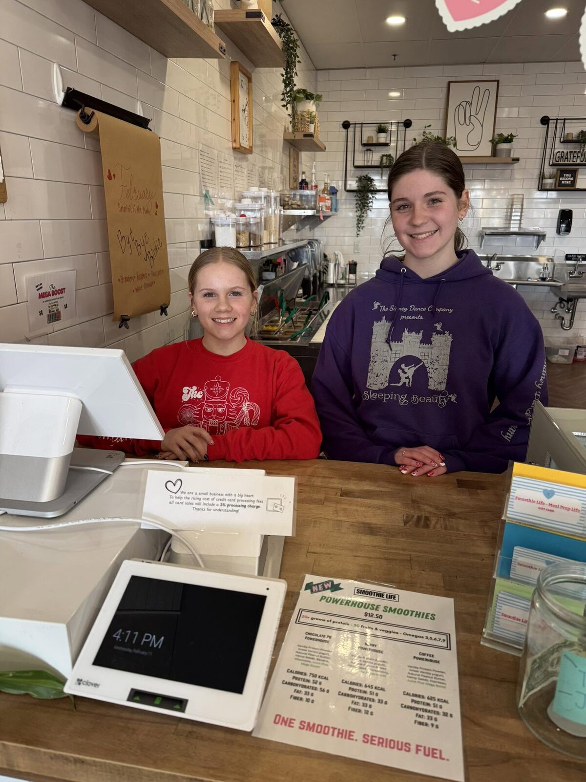 Two of the team at the counter by the register