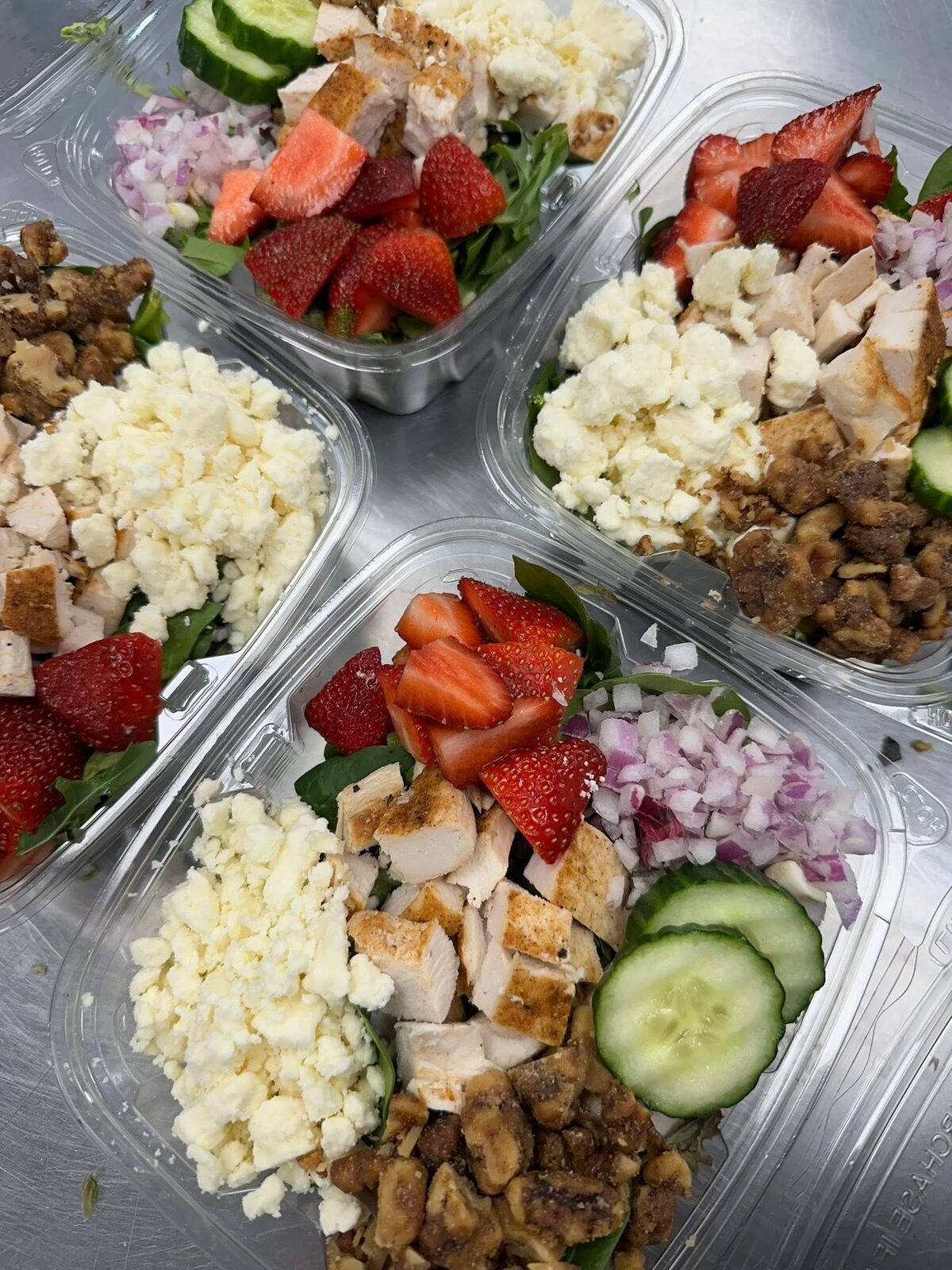 Salads with strawberries, walnuts and feta in to-go boxes