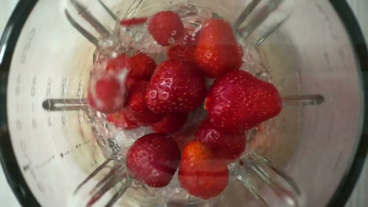 Strawberries blending, seen from above — a stock clip, not filmed at the shop