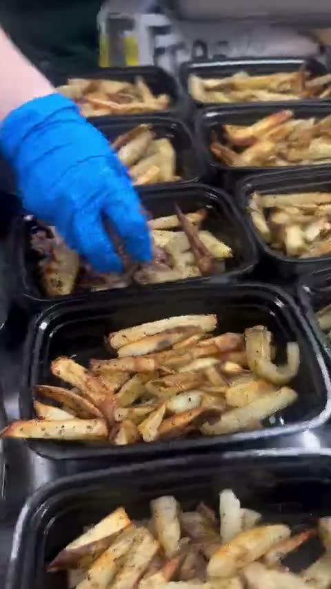 Gloved hands putting baked fries into meal-prep boxes — Meal Prep Life reel