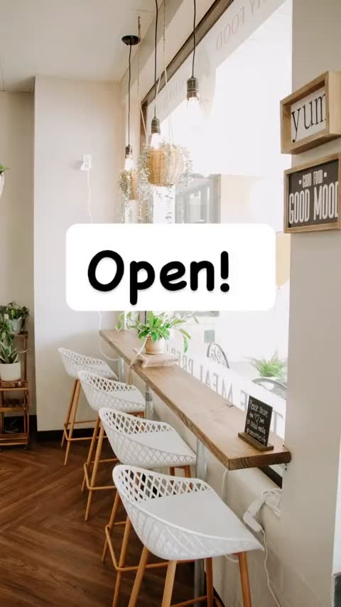 The empty shop at opening, stools along the window bar — her reel: Open!