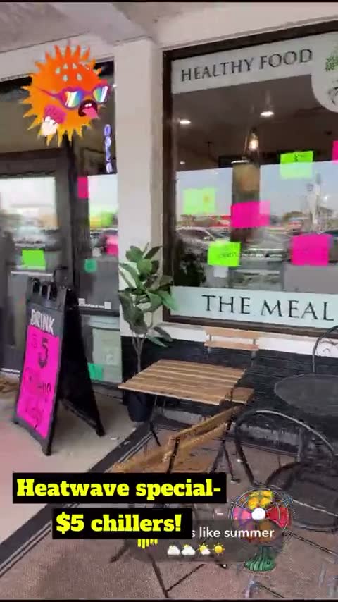 The storefront in a heatwave with pink signs in the window — her reel: $5 chillers, all day today and tomorrow